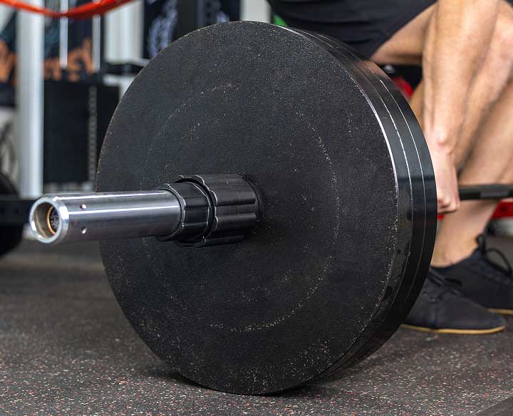 man deadlifting with husker power lock on barbell